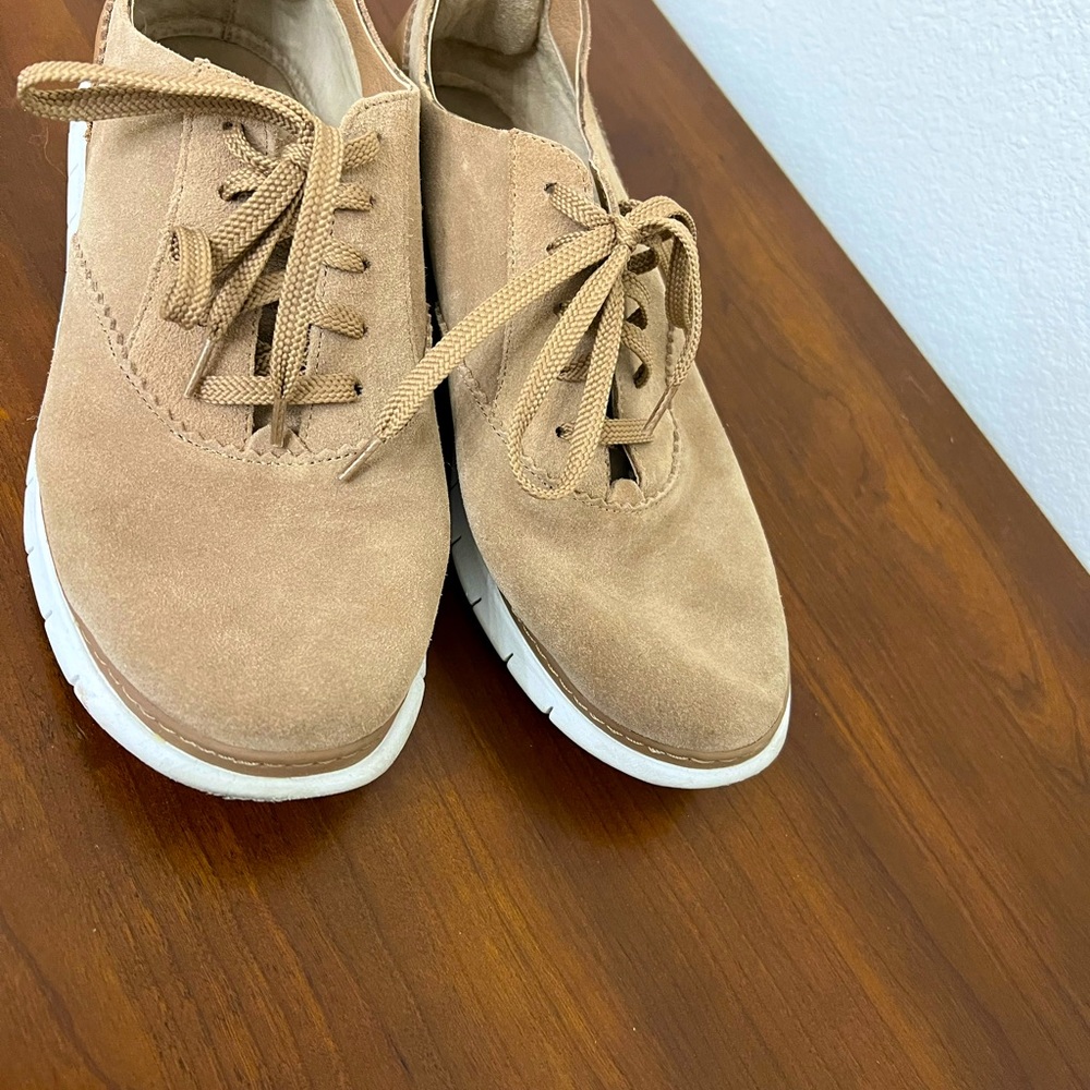 Vionic shoe. Tan in color. Moderately worn.